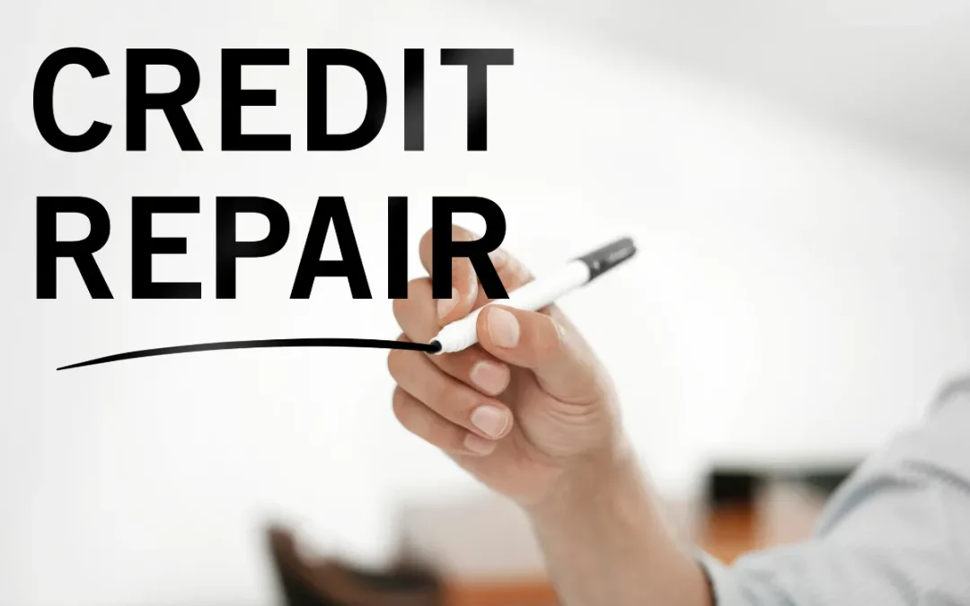 A hand writing the words 'CREDIT REPAIR' with a marker on a clear surface.