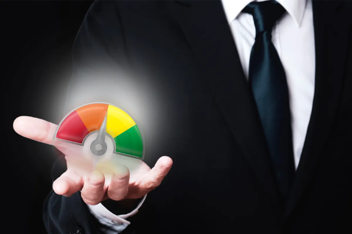 A person in a suit displaying a holographic gauge indicating a red zone, suggesting risk or evaluation.