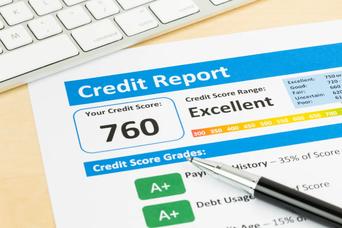 Credit report with a score of 760 rated 'Excellent' and a pen, with a keyboard in the background.