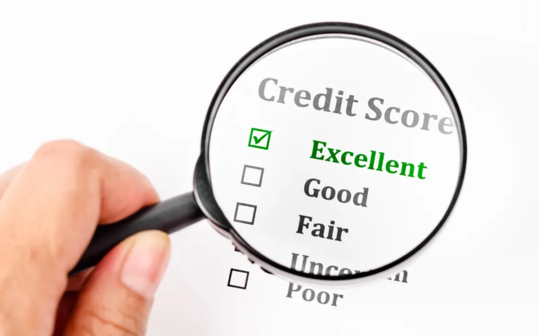 Magnifying glass highlighting the word 'Excellent' on a credit score checklist.
